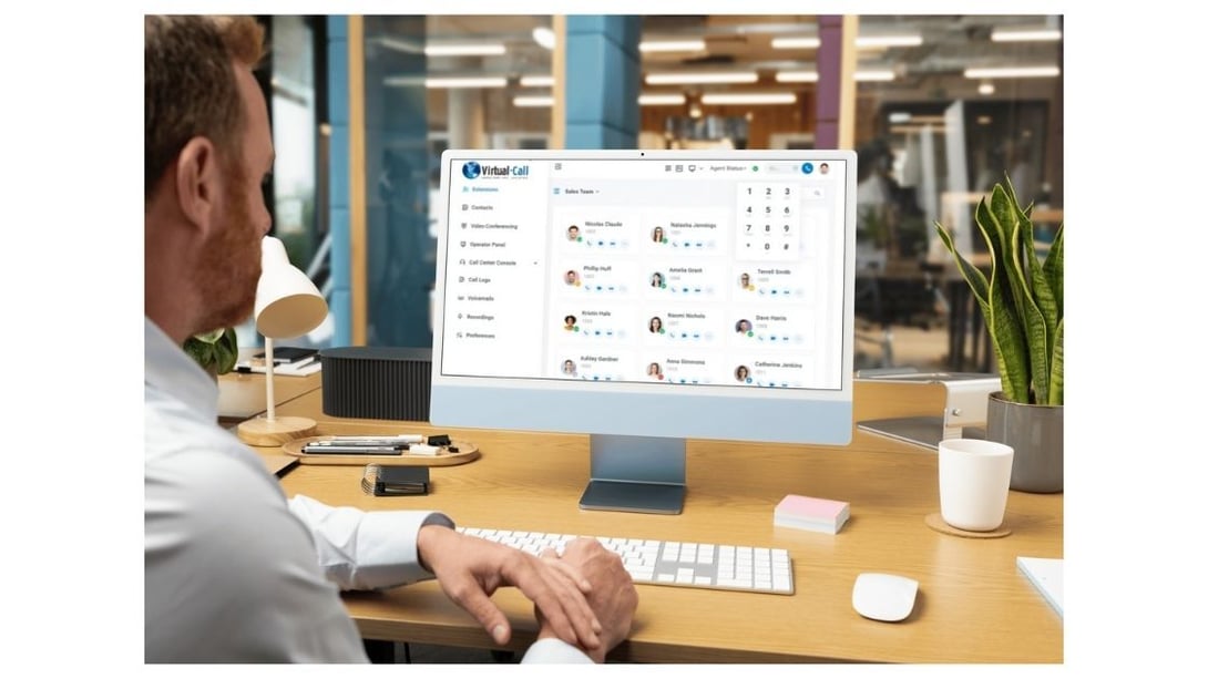 Professional using Virtual-Call's cloud telephony platform on a desktop, illustrating integrated systems as a key benefit of digital transformation in telecom.