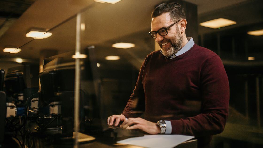 IT consultant managing a company's network using his office computer.